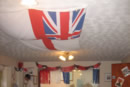 <Larchmere's dining room draped with flags and ensigns for 1940s day>