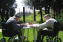 <Residents of Larchmere House enjoy a game of cards in the garden>