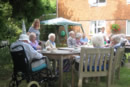 <Residents of Larchmere House enjoy tea in the garden>